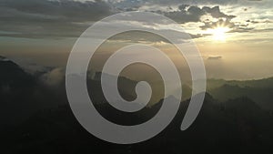 Aerial shot of sunrise over the misty hills around Mount Bromo