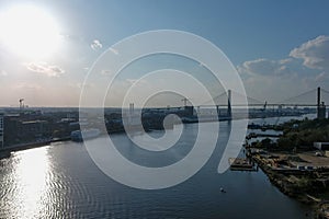 aerial shot of the Talmadge Memorial Bridge over the blue waters of the Savannah River surrounded by lush green trees