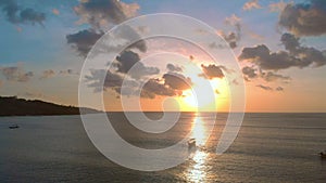 Aerial shot of three fisherman`s boats in a sea at sunset time. Drone moves to the right