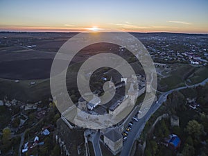 Aerial shot towards a sunset behind Kamianets-Podilskyi castle