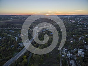 Aerial shot towards a sunset behind Kamianets-Podilskyi castle