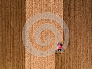 Aerial shot of a tractor cultivating field at spring photo