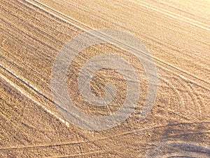 Aerial shot of tractor tracks in a field.