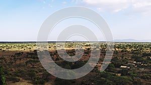Aerial shot of traditional African rural tribe village, East Africa. Aerial footage savannah grassland landscape in