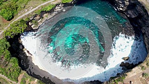 Aerial shot of the turquoise blue water in hole Broken Beach. Famous tourist place on the Nusa Penida island, Indonesia.