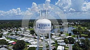 Aerial shot of the water tower in Leesburg, Florida under the clouds