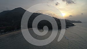 Aerial shot of waves and beautiful sunset on Surin beach in Phuket