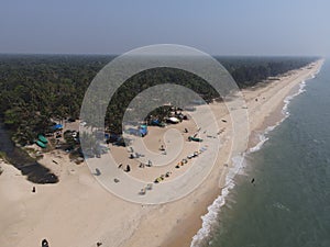 Aerial shot of waves washing up the shore Alleppey beach in India