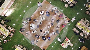 Aerial shot of wedding day, bride, groom. Dancing people outdoor. Romantic day top view.