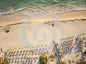 Aerial shot. White sandy beach with parasols. warm clear sea. Bright sunny day. Beautiful seascape, romance, vacation, vacation,