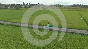 Aerial shot of a young woman doing meditation for Muladhara chakra in a Balinese way