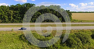 Aerial side view to highway road with cars, countryside rural la