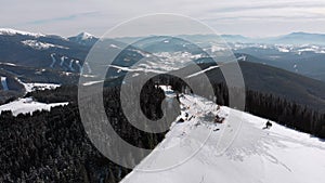 Aerial Ski Slopes with Skiers and Ski Lifts on Ski Resort. Snowy Mountain Forest