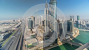 Aerial skyline of Dubai's business bay with skyscrapers timelapse before sunset.