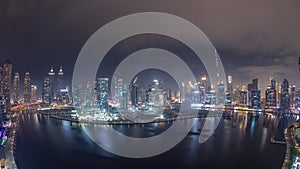 Aerial skyline panorama of Dubai Business Bay and Downtown with the various skyscrapers and towers night timelapse