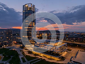 Aerial skyline view about the famous Mol campus modern office building next to Danube river at sunset.