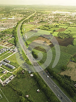 Aerial of SLEX and STAR Tollway in Sto Tomas, Batangas. Empty fields and subdivisions