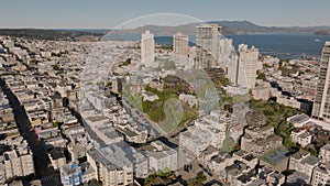 Aerial slide and pan footage of Russian Hill, Vallejo Street Crest District. Group of old houses on green hill