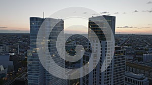 Aerial slide and pan footage of tops of modern hotel buildings against colour sunset sky. Charlottenburg neighbourhood