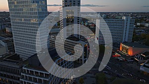 Aerial slide and pan of modern high rise hotel buildings and traffic on street around. City at twilight. Charlottenburg