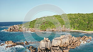 Aerial slider over granite sculptures Grand l`Anse rising from water