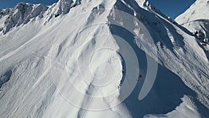 Aerial: the slopes of high mountains with marks from skis and snowboards