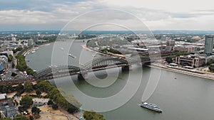 Aerial slow left pan of the Rhine River and cityscape of Cologne, Germany.