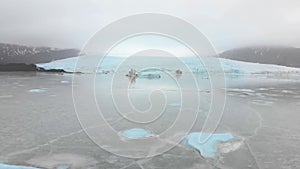 Aerial slow motion rising view Fjallsjokull glacier. The wonderful glacier lagoon of FjallsÃ¡rlÃ³n in Iceland