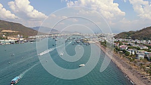 Aerial slow motion shot of touristic boats in a busy Nha Trang harbor. Travel to Vietnam concept.