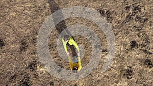 Aerial slow motion view of girlfriends having fun and holding their hands in the outdoors