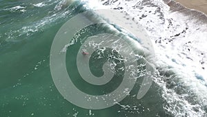 Aerial slow motion view of woman swimming in the sea at tropical island