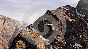 Aerial of snowy mountain range with snow