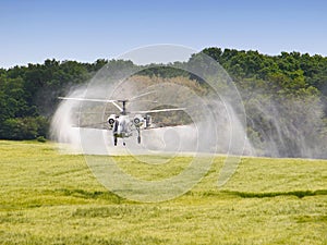 Aerial spraying over a field of wheat