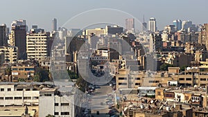 Aerial static Cairo old cityscape panorama with apartment buildings. Vehicles drive in old neighborhood streets. Egypt