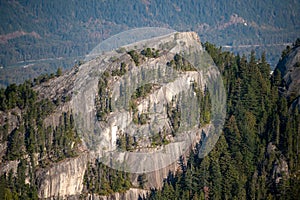 Aerial of the Stawamus Chief Mountain, granitic dome with leafy trees in Squamish in Canada