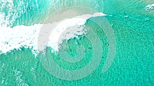 Aerial Still Top Down View over waves with bodyboarders in tropical clear ocean
