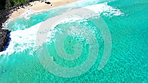 Aerial still view over clear turquoise blue ocean waves tropical Hawaii beach