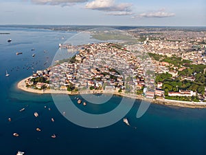 Aerial. Stone town, Zanzibar, Tanzania. Flock of Show Ships near the Zanzibar Coastline in Stone Town on Blue