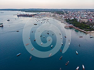 Aerial. Stone town, Zanzibar, Tanzania. Flock of Show Ships near the Zanzibar Coastline in Stone Town on Blue