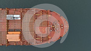 Aerial straight down view of the bow of an empty cargo ship at sea