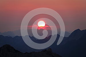 AERIAL: Stunning shot of colorful evening sky above the untouched Julian Alps.