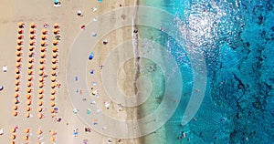 AERIAL. Summer beach with people and turquoise ocean water