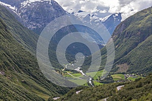 Aerial summer view of mountain road in green valley in Norway selective focus, View from the viewpoint