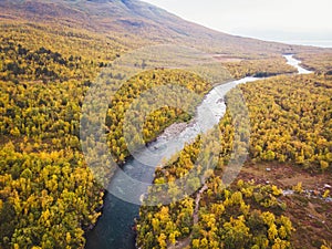 Aerial sunny fall autumn view of Abisko National Park, Kiruna Municipality, Lapland, Norrbotten County, Sweden, shot from drone,