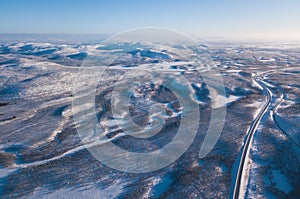 Aerial sunny winter view of Abisko National Park, Kiruna Municipality, Lapland, Norrbotten County, Sweden, shot from drone, with r