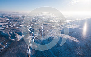 Aerial sunny winter view of Abisko National Park, Kiruna Municipality, Lapland, Norrbotten County, Sweden, shot from drone, with r