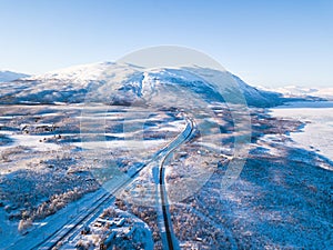 Aerial sunny winter view of Abisko National Park, Kiruna Municipality, Lapland, Norrbotten County, Sweden, shot from drone, with r