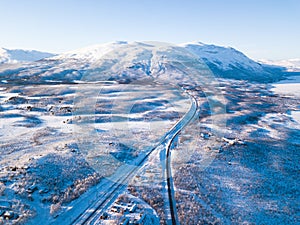 Aerial sunny winter view of Abisko National Park, Kiruna Municipality, Lapland, Norrbotten County, Sweden, shot from drone, with r