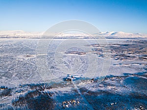 Aerial sunny winter view of Abisko National Park, Kiruna Municipality, Lapland, Norrbotten County, Sweden, shot from drone, with r photo