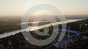 AERIAL: Sunrise over the Dnipro River and Dynamo Kyiv Lobanovskyi Stadium, Kyiv, Ukraine. Drone footage of Kyiv city at